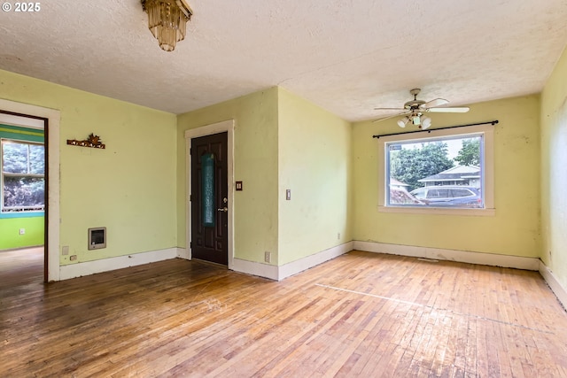 6861 N Sky St, Portland, OR 97203 - unfurnished room featuring light wood-type flooring, a textured ceiling, ceiling fan, heating unit, and baseboards