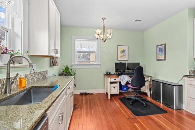 office featuring light hardwood / wood-style floors, sink, and a notable chandelier