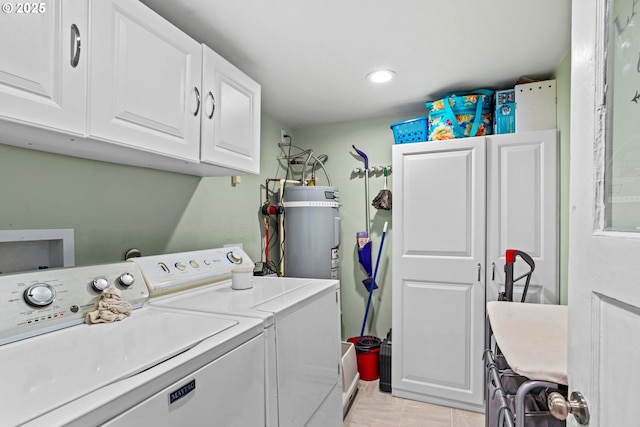 laundry area featuring cabinets, separate washer and dryer, light tile patterned floors, and strapped water heater