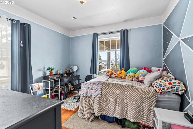 bedroom with hardwood / wood-style floors