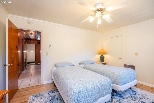 bedroom featuring ornamental molding, hardwood / wood-style floors, and ceiling fan