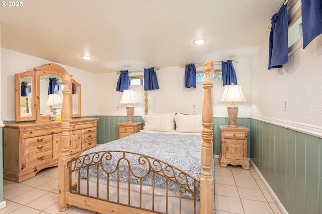 bedroom featuring light tile patterned floors and a textured ceiling