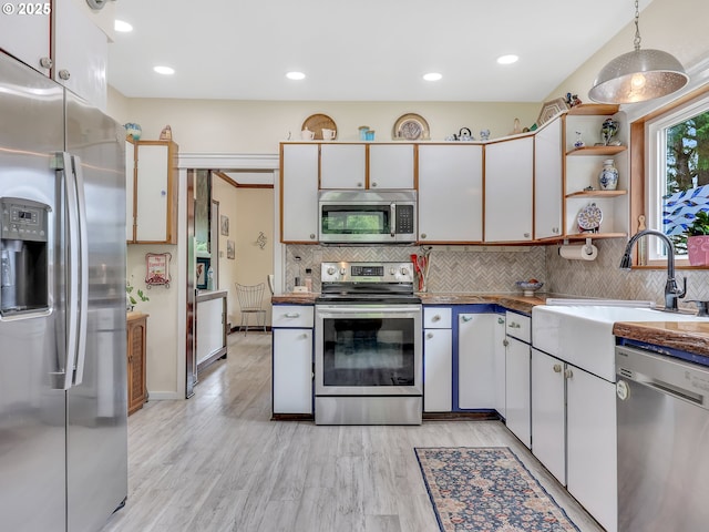 91196 Youngs River Rd, Astoria, OR 97103 - kitchen featuring stainless steel appliances, backsplash, open shelves, light wood finished floors, and recessed lighting