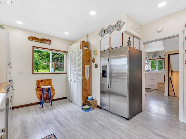 91196 Youngs River Rd, Astoria, OR 97103 - kitchen featuring stainless steel fridge with ice dispenser, separate washer and dryer, light wood-type flooring, and recessed lighting