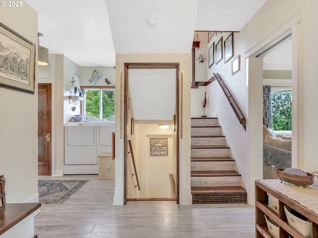91196 Youngs River Rd, Astoria, OR 97103 - stairway featuring washer and clothes dryer, plenty of natural light, and wood finished floors