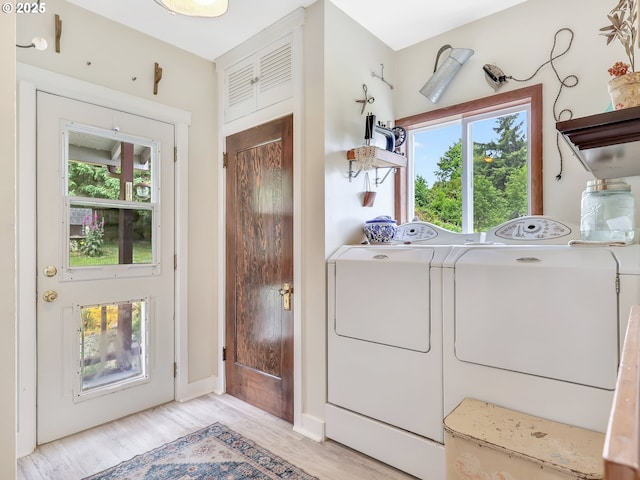91196 Youngs River Rd, Astoria, OR 97103 - washroom with washer and clothes dryer, light wood-type flooring, and plenty of natural light