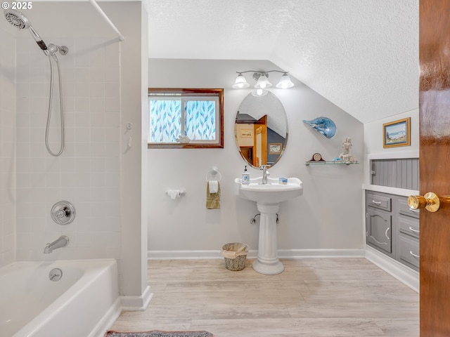 91196 Youngs River Rd, Astoria, OR 97103 - full bath featuring a textured ceiling, lofted ceiling, shower / tub combination, and wood finished floors