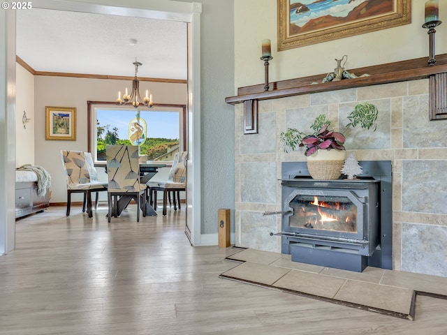 91196 Youngs River Rd, Astoria, OR 97103 - living area with crown molding, a chandelier, wood finished floors, and a fireplace