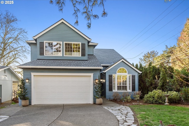 traditional-style home featuring an attached garage, concrete driveway, and roof with shingles