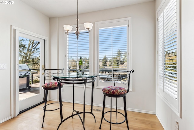 dining room with light wood-style flooring and a wealth of natural light