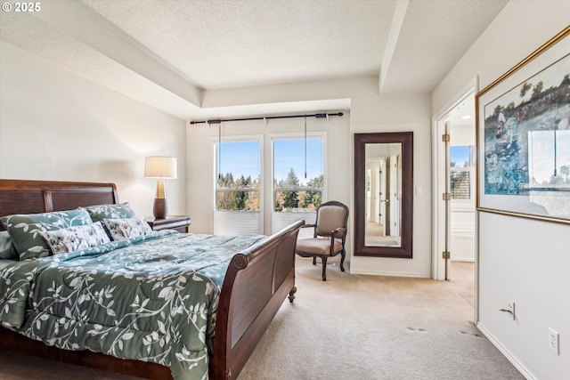 carpeted bedroom featuring baseboards and a textured ceiling