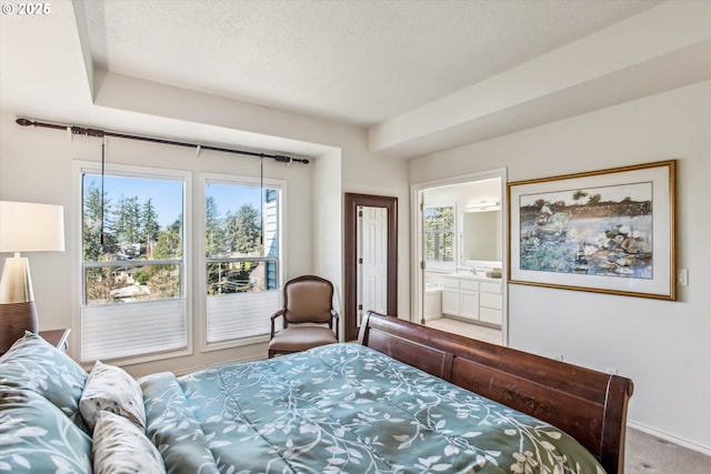 bedroom featuring carpet floors, connected bathroom, baseboards, and a textured ceiling