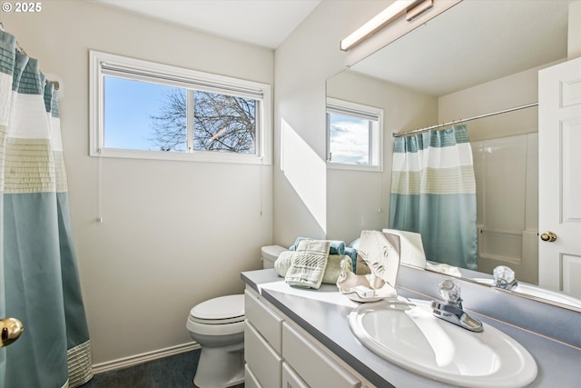 bathroom featuring toilet, a shower with curtain, baseboards, and vanity