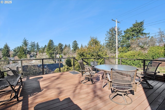 wooden terrace with outdoor dining space