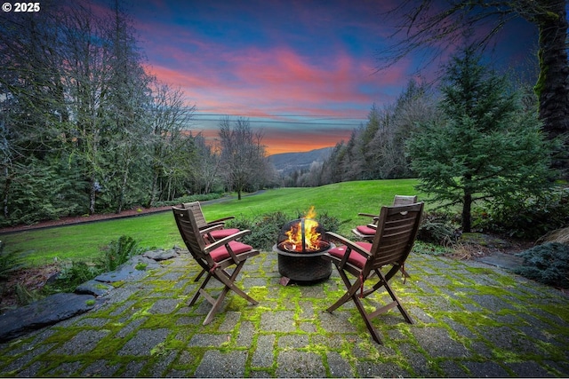 exterior space featuring a patio, an outdoor fire pit, and a mountain view