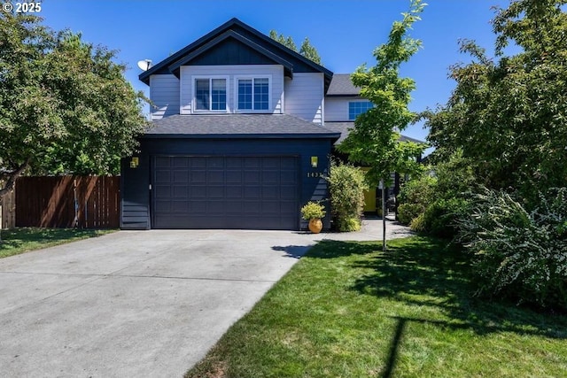 traditional-style home featuring an attached garage, fence, driveway, a front lawn, and board and batten siding