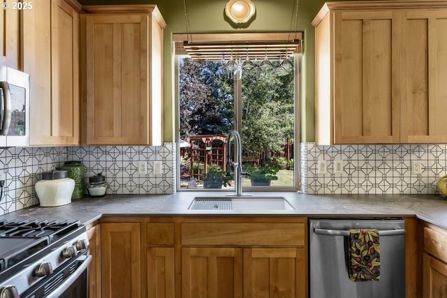 kitchen with backsplash, stainless steel appliances, and a sink