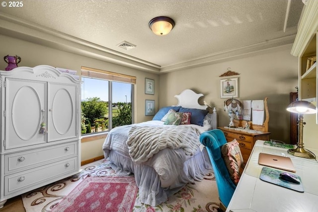 bedroom with visible vents and a textured ceiling