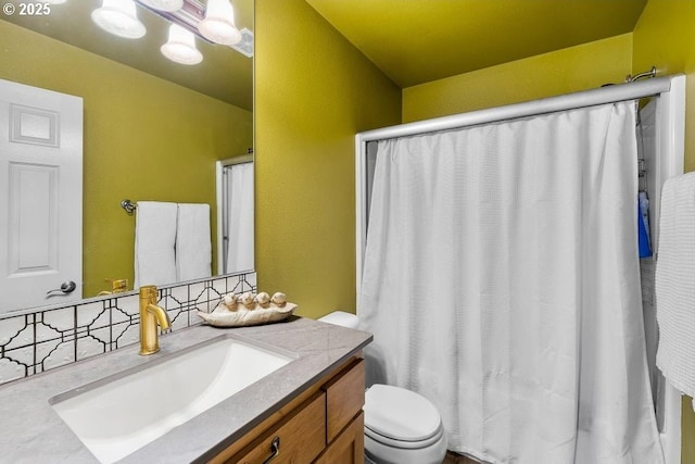 full bathroom with toilet, an inviting chandelier, a shower with shower curtain, and vanity