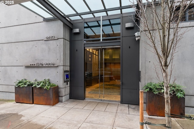 property entrance featuring a patio area and stucco siding