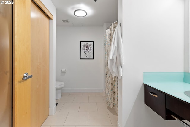 bathroom with visible vents, baseboards, toilet, tile patterned floors, and vanity