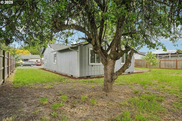 view of home's exterior featuring board and batten siding, a yard, crawl space, and fence