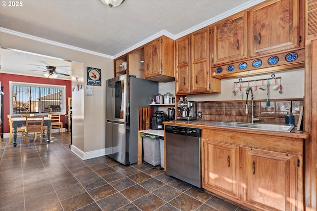 kitchen featuring sink, appliances with stainless steel finishes, crown molding, and ceiling fan