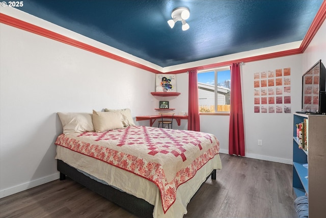 bedroom featuring dark hardwood / wood-style flooring and ornamental molding