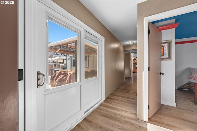 hallway with light hardwood / wood-style flooring