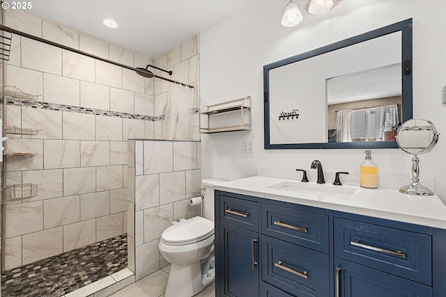 bathroom with a shower with shower curtain, vanity, and toilet