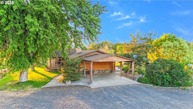 73594 Davis Ln, Pendleton, OR 97801 - view of front of house with driveway, a carport, a chimney, and roof with shingles