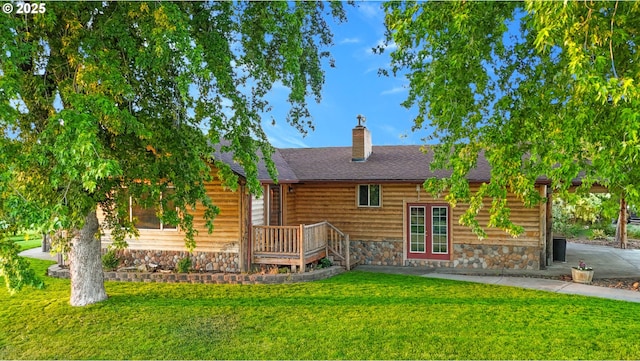 73594 Davis Ln, Pendleton, OR 97801 - back of property featuring a yard, a chimney, stone siding, and roof with shingles