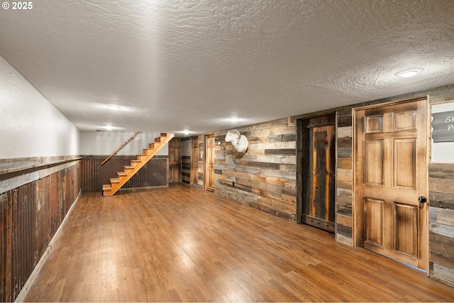73594 Davis Ln, Pendleton, OR 97801 - finished below grade area featuring wooden walls, wood finished floors, stairway, wainscoting, and a textured ceiling