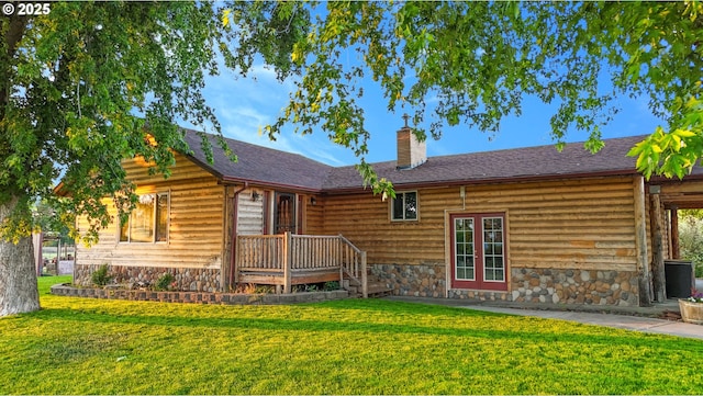 73594 Davis Ln, Pendleton, OR 97801 - back of house with a chimney, a lawn, stone siding, and a shingled roof
