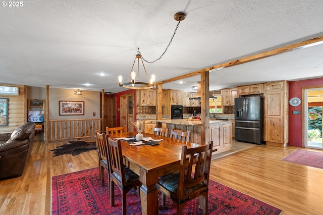 73594 Davis Ln, Pendleton, OR 97801 - dining room featuring a chandelier, light wood-type flooring, and a textured ceiling