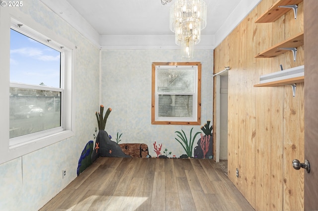 empty room featuring light wood-style flooring and a chandelier