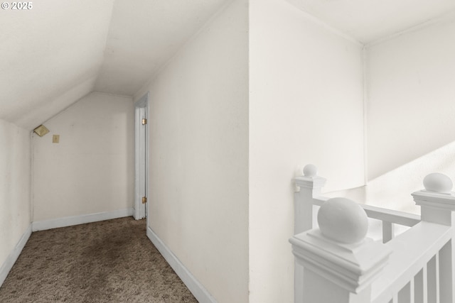 interior space featuring lofted ceiling, carpet, and baseboards