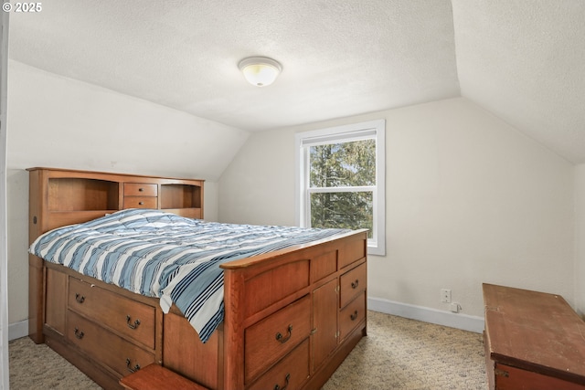 bedroom featuring light carpet, vaulted ceiling, a textured ceiling, and baseboards