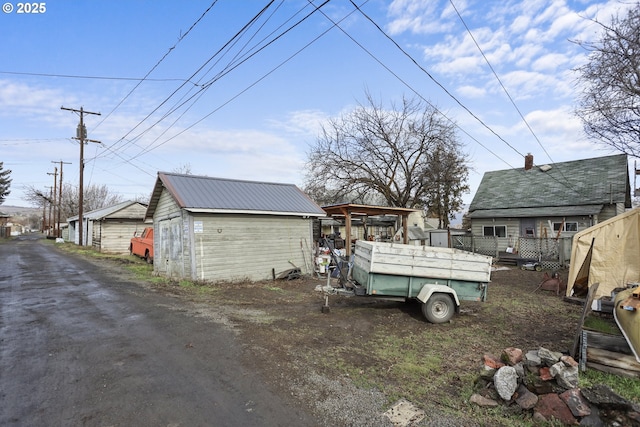 exterior space with metal roof and an outdoor structure