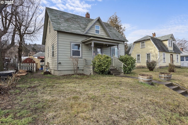 view of front of home featuring a chimney and a front yard