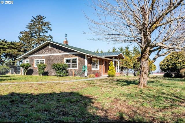 view of front of property featuring a front yard and a chimney