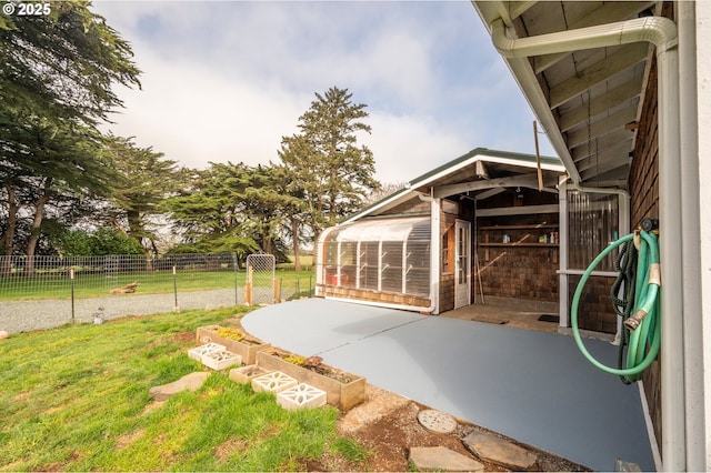 exterior space featuring an outdoor structure and fence