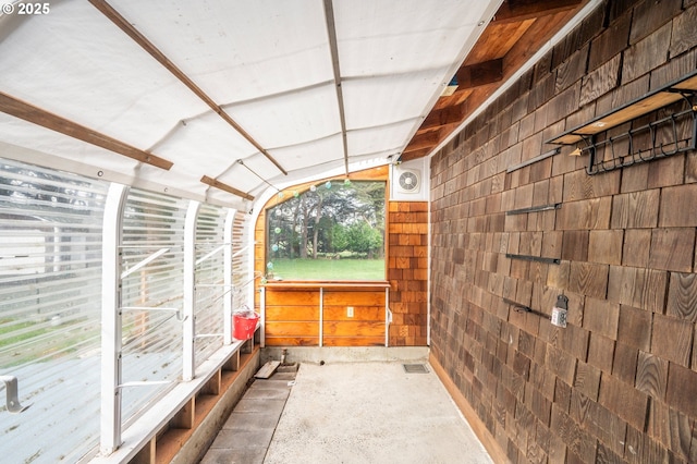 unfurnished sunroom with lofted ceiling