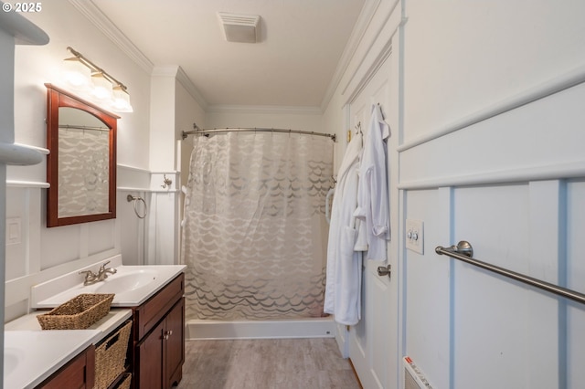 bathroom featuring ornamental molding, wood finished floors, vanity, and a shower with curtain