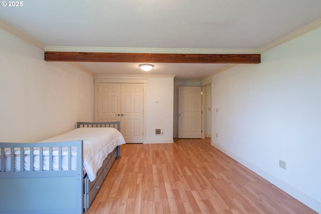 unfurnished bedroom featuring light wood-type flooring, visible vents, and ornamental molding