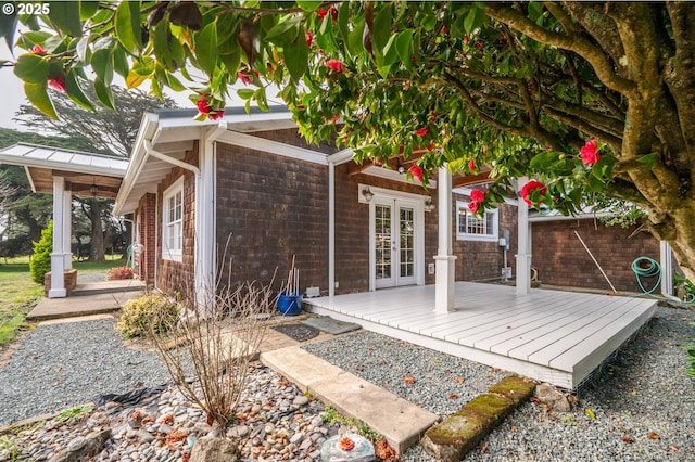 view of patio / terrace with fence, a deck, and french doors