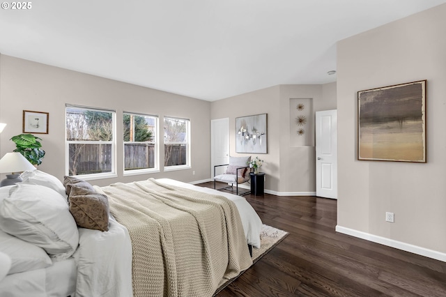 bedroom with dark hardwood / wood-style floors