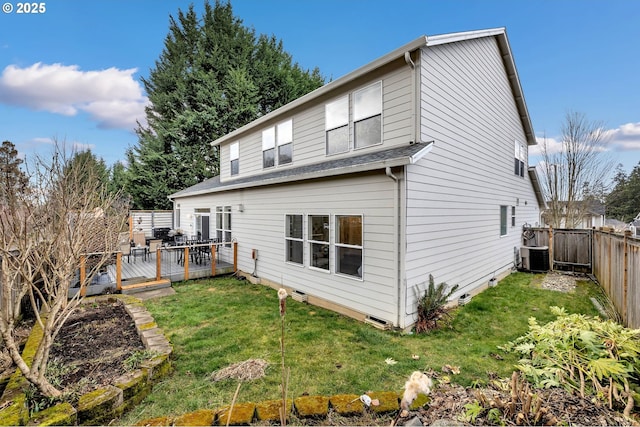 rear view of house featuring a yard, a deck, and central AC