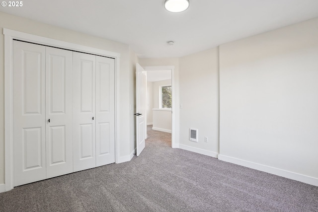 unfurnished bedroom with carpet flooring and a closet