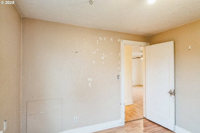 unfurnished bedroom featuring baseboards and light wood-type flooring